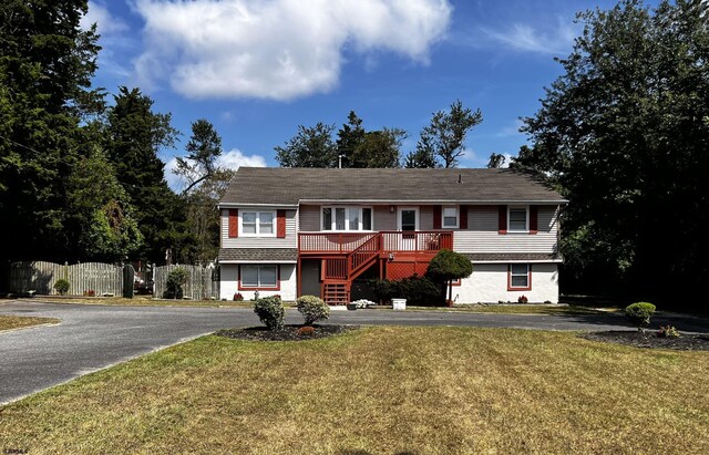 view of front of house featuring a front yard and a deck