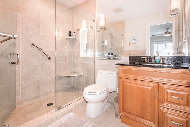 bathroom with ceiling fan, vanity, tile patterned floors, walk in shower, and toilet