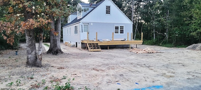 rear view of house featuring a deck