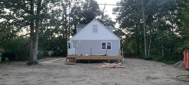 rear view of property featuring a wooden deck