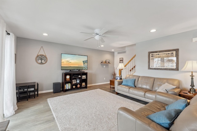 living room with light wood-type flooring and ceiling fan