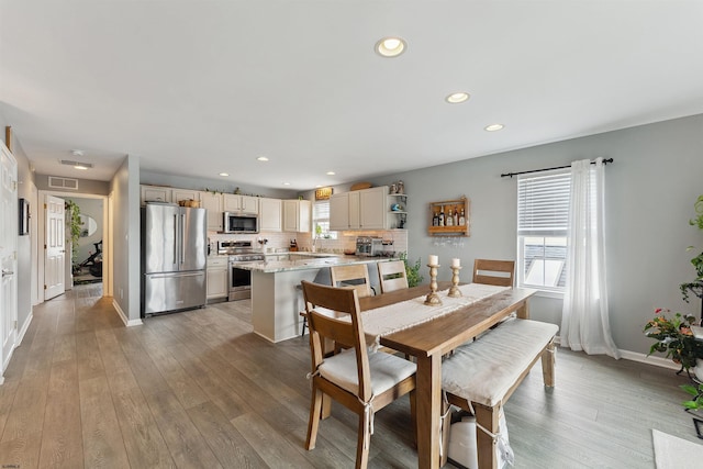 dining space with light wood-type flooring and sink