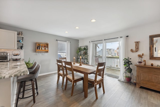 dining space with light hardwood / wood-style floors