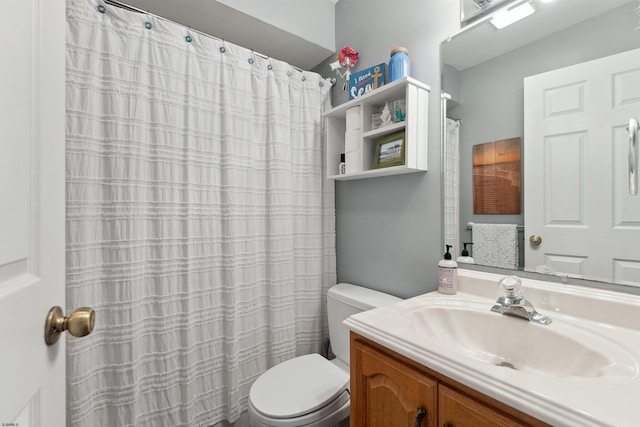 bathroom featuring vanity, toilet, and curtained shower