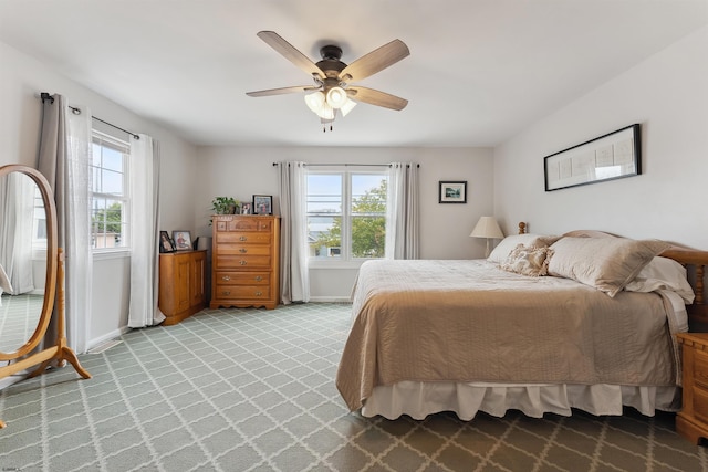 bedroom featuring light carpet and ceiling fan