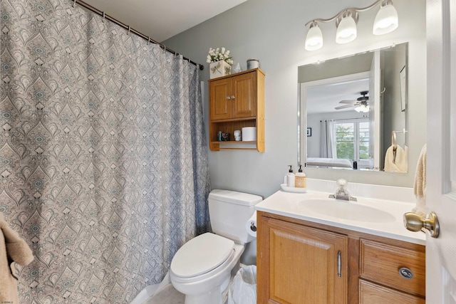 bathroom featuring ceiling fan, vanity, toilet, and curtained shower