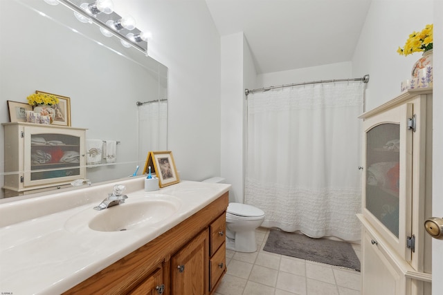 bathroom featuring a shower with shower curtain, tile patterned flooring, vanity, and toilet