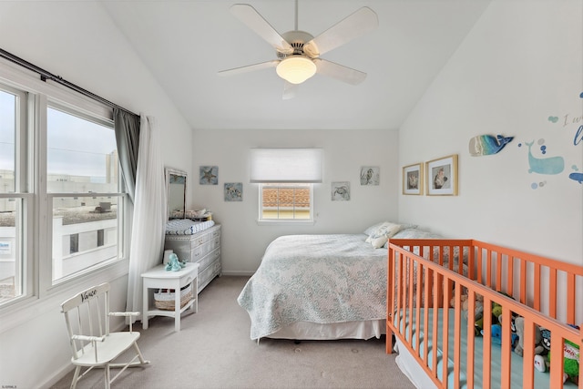 carpeted bedroom with ceiling fan, lofted ceiling, and multiple windows