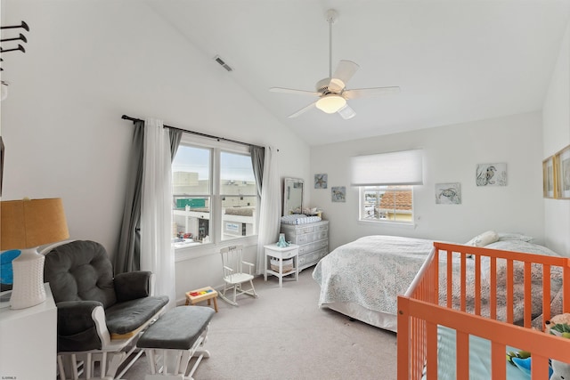 carpeted bedroom featuring ceiling fan and high vaulted ceiling