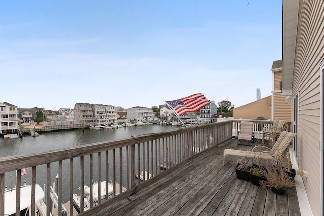 wooden terrace featuring a water view