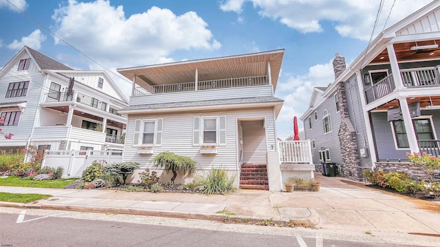 view of front of house featuring a balcony