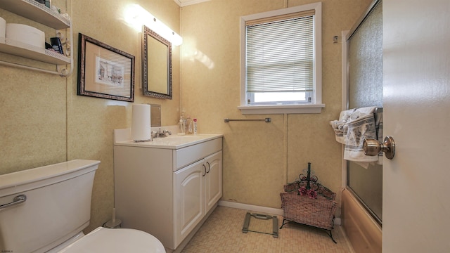 full bathroom with tile patterned floors, bath / shower combo with glass door, vanity, and toilet