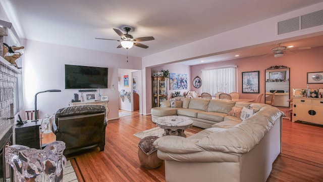 living room featuring ceiling fan and light hardwood / wood-style flooring