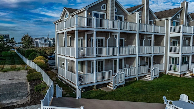 exterior space with a balcony and a front lawn