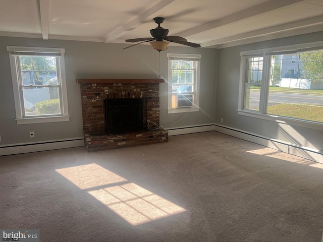 unfurnished living room featuring a brick fireplace, beam ceiling, ceiling fan, and plenty of natural light