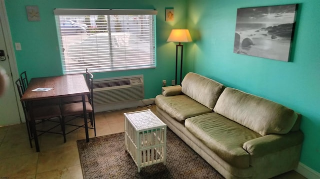 living room with a wall mounted AC and tile patterned flooring