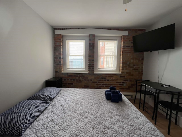 bedroom with brick wall and ceiling fan