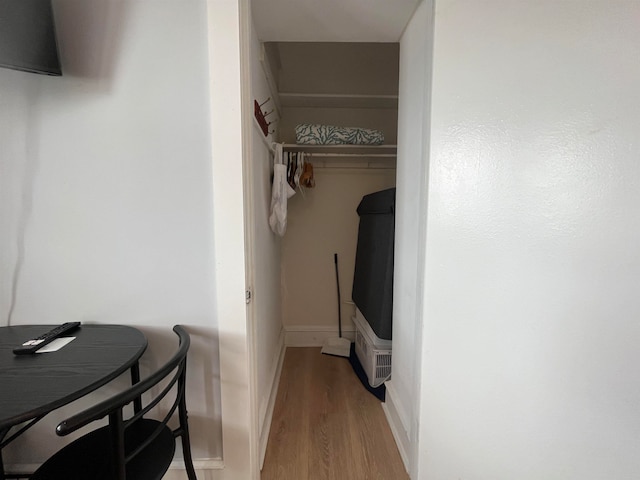 clothes washing area with light wood-type flooring