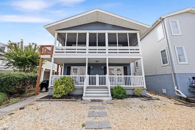 view of front of house featuring a sunroom and covered porch