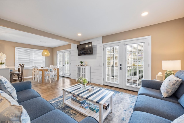 living room featuring hardwood / wood-style flooring, french doors, and a wealth of natural light