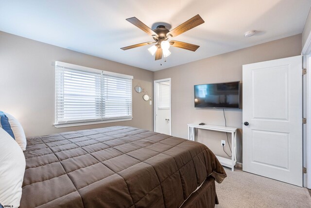 bedroom with ceiling fan and light colored carpet