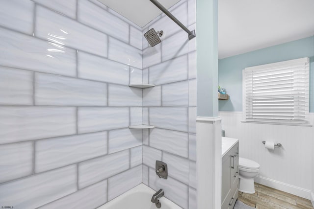 full bathroom with tiled shower / bath, vanity, toilet, and hardwood / wood-style flooring