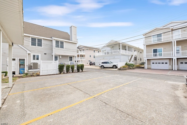 view of car parking featuring a garage