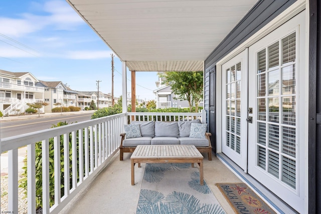 balcony featuring covered porch and french doors