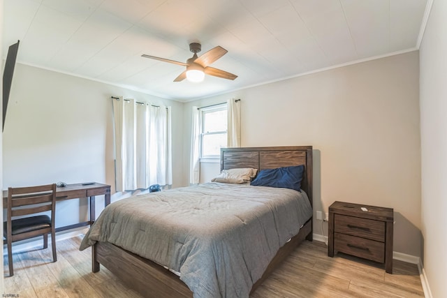 bedroom with ornamental molding, light wood-type flooring, and ceiling fan