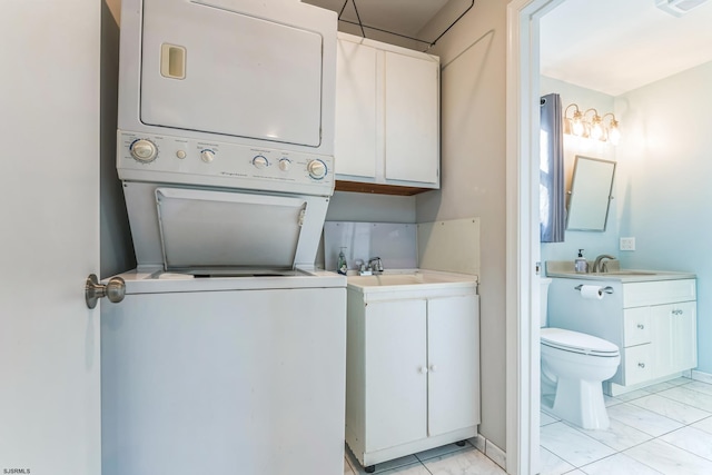 laundry room featuring stacked washer and dryer and sink