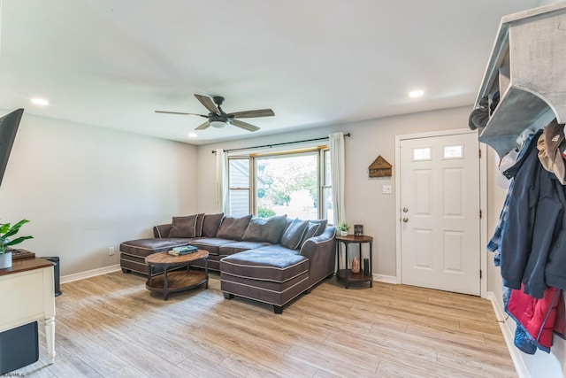 living room with light wood-type flooring and ceiling fan