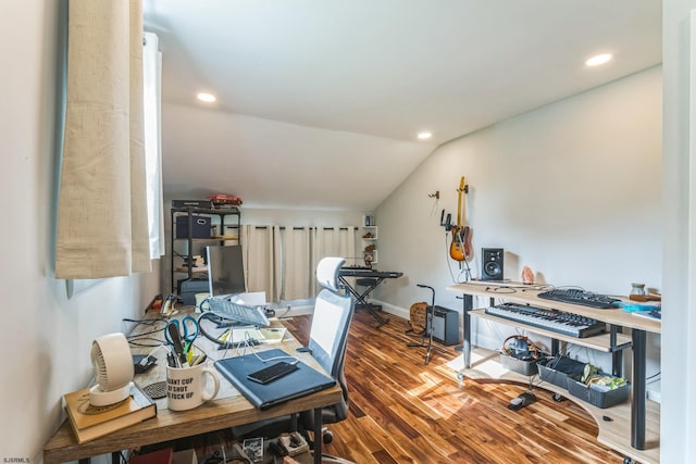 home office with vaulted ceiling and hardwood / wood-style flooring