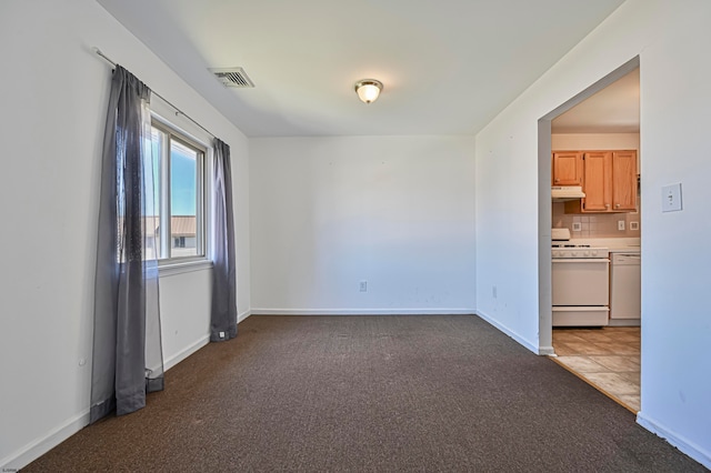 empty room featuring dark carpet