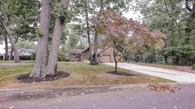 view of front of property with a front yard and a garage