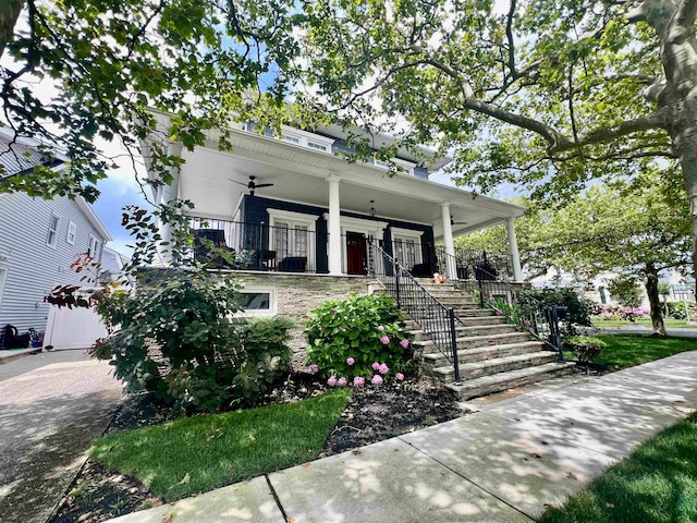 view of front facade with ceiling fan and a porch