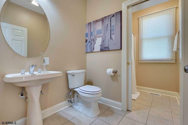 bathroom featuring tile patterned flooring and toilet