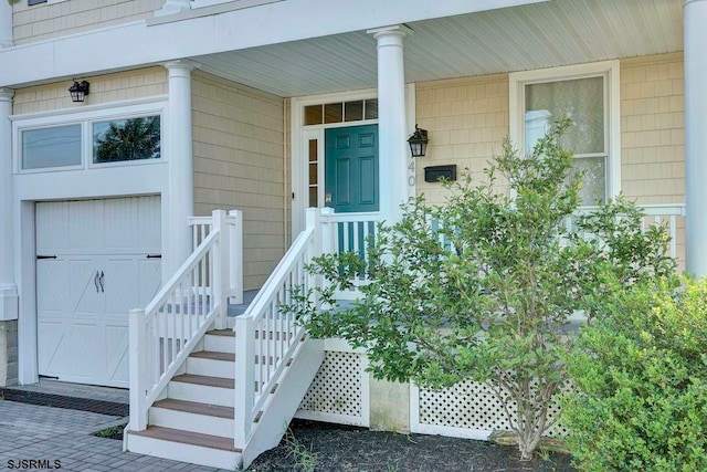 property entrance with a porch and a garage