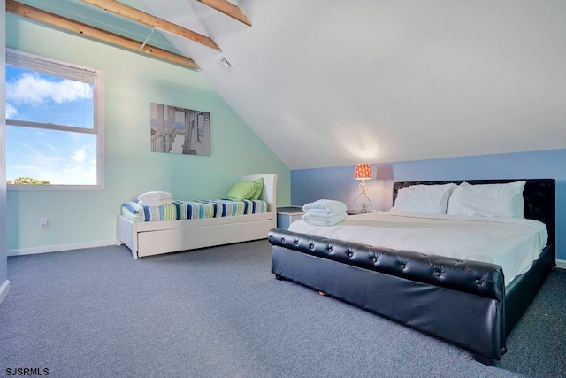 bedroom with dark colored carpet and vaulted ceiling with beams