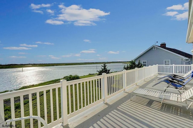 wooden deck featuring a water view