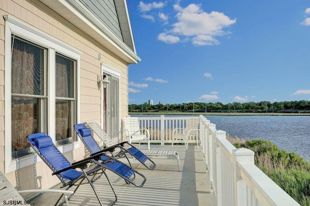 balcony featuring a water view