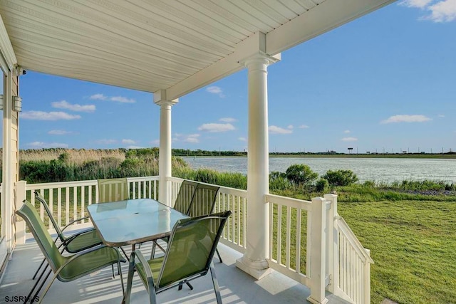 balcony featuring a water view and covered porch