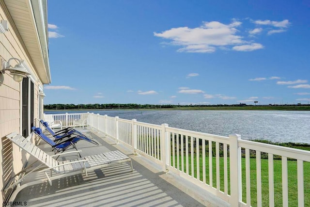 deck featuring a water view and a yard