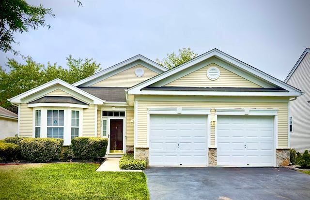 view of front facade with a front yard and a garage