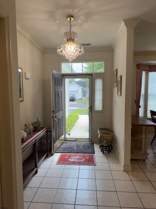 entrance foyer with crown molding, light tile patterned floors, and a chandelier