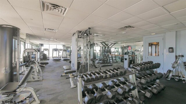 gym with a paneled ceiling