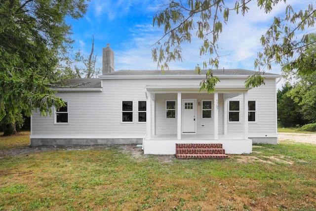 view of front of property with covered porch and a front yard