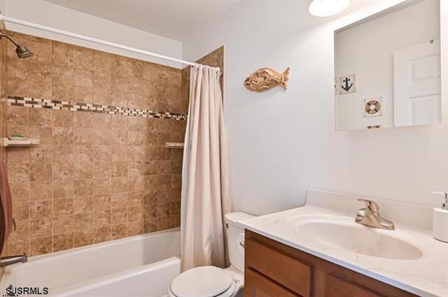 full bathroom with shower / bath combination with curtain, vanity, and toilet