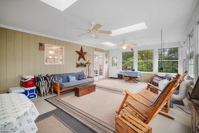 living room with french doors, a skylight, ceiling fan, and crown molding