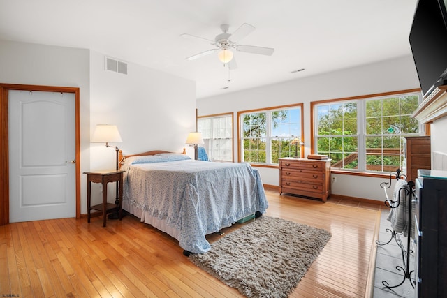 bedroom with ceiling fan and light hardwood / wood-style flooring