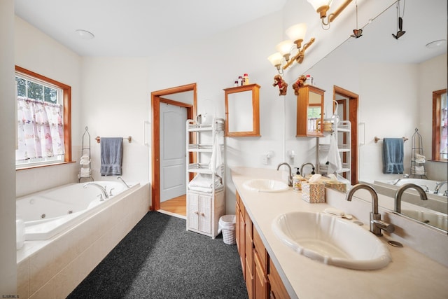 bathroom with tiled tub and vanity